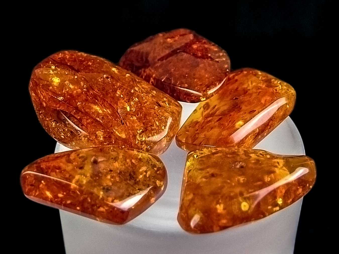 A pile of polished golden-orange amber stones