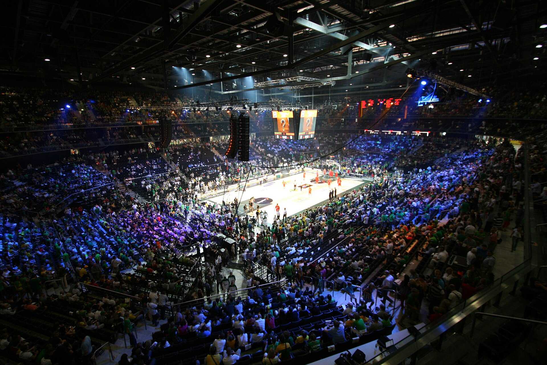 A packed basketball arena full of fans during a game