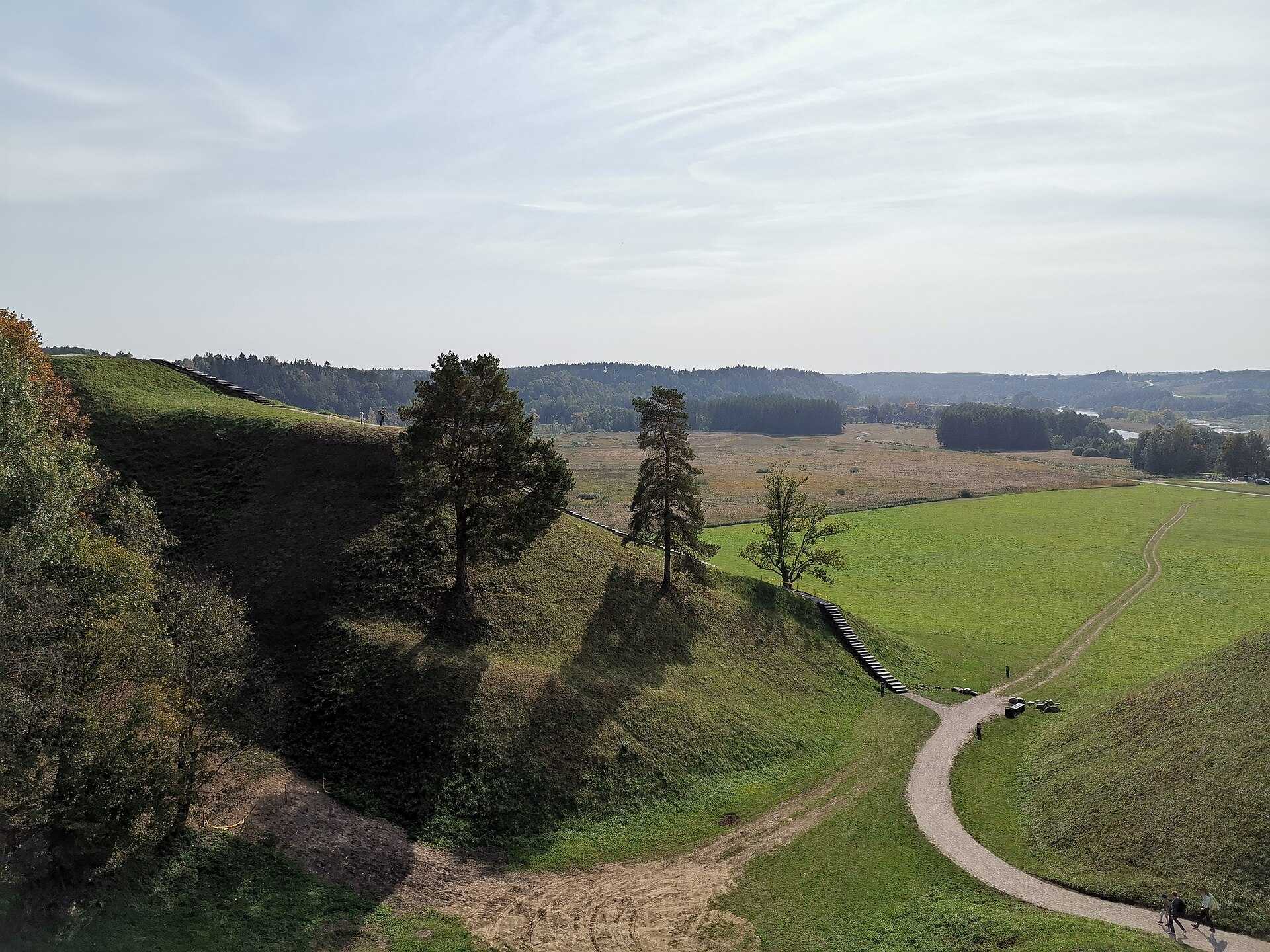 Round grassy hills rising above a river valley