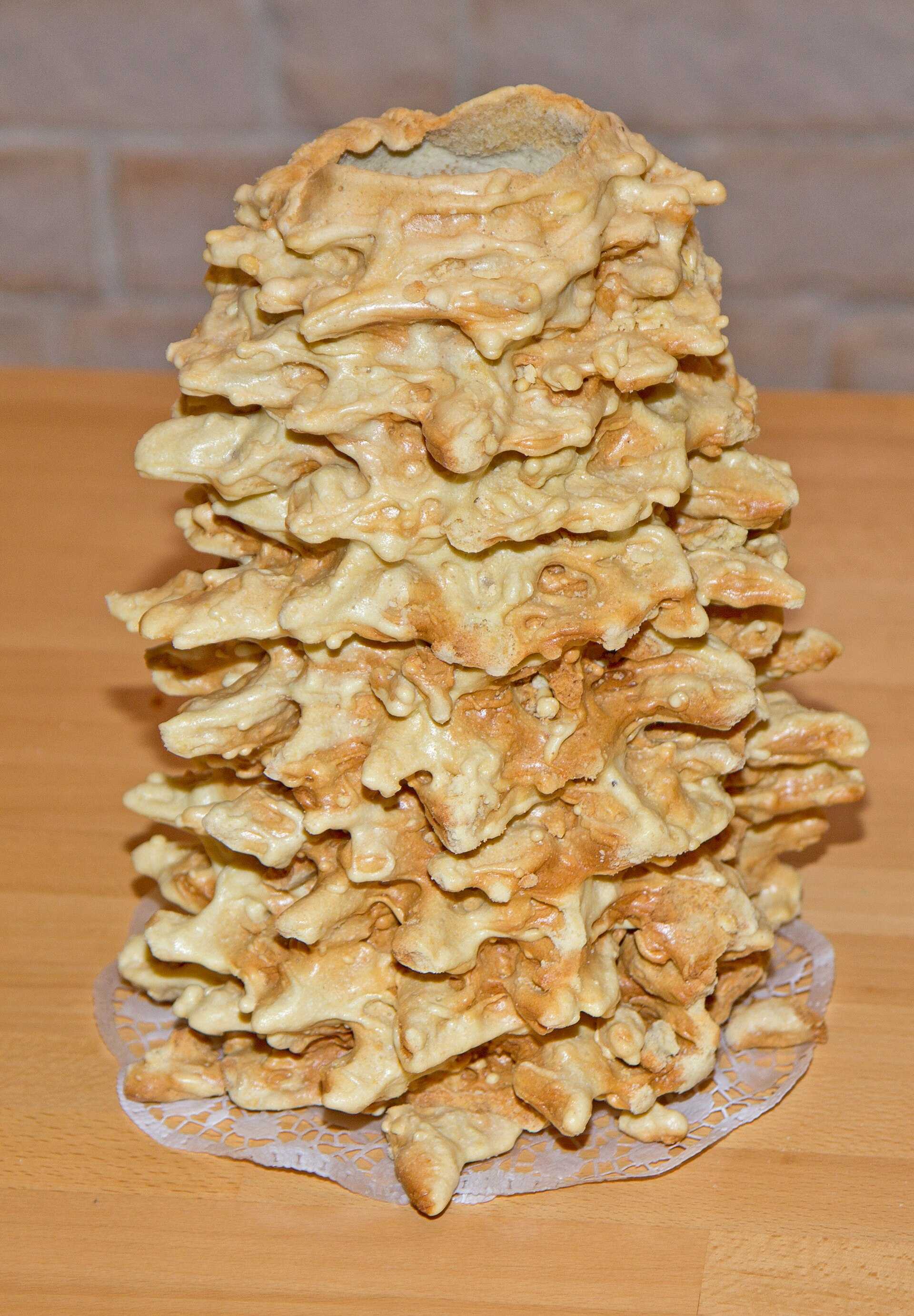 A tall golden cake covered in spiky branches