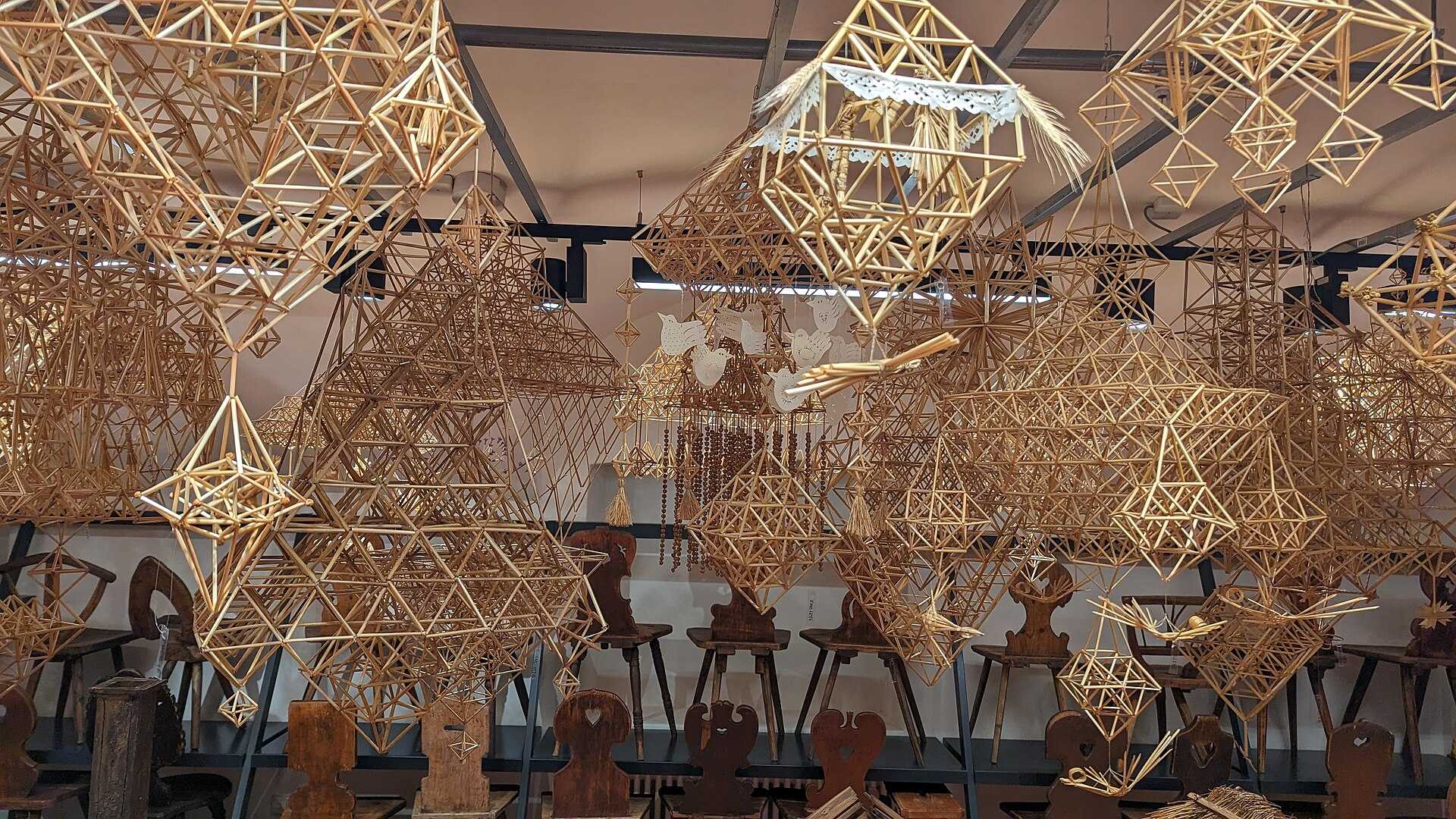 A hanging geometric ornament made of straw